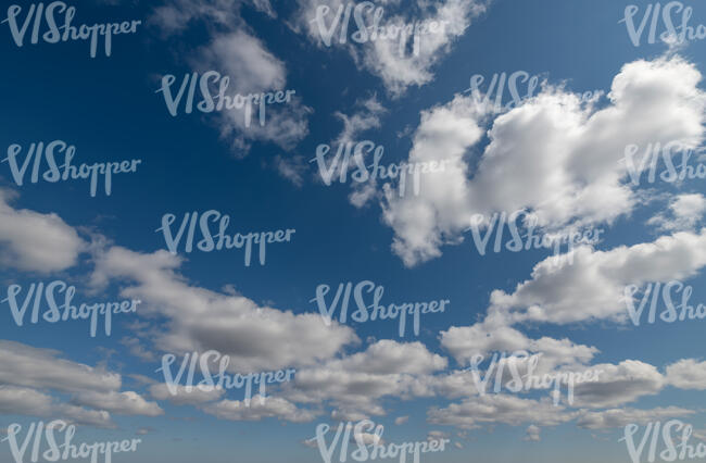 deep blue sky with small white clouds