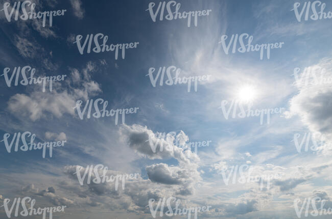 daytime sky with sun and clouds