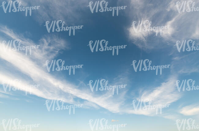 daytime sky with a line of thin clouds