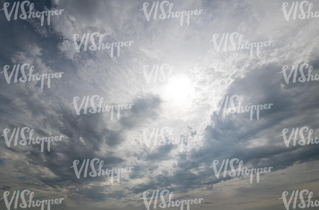 sky covered with thin grey clouds and sun shining