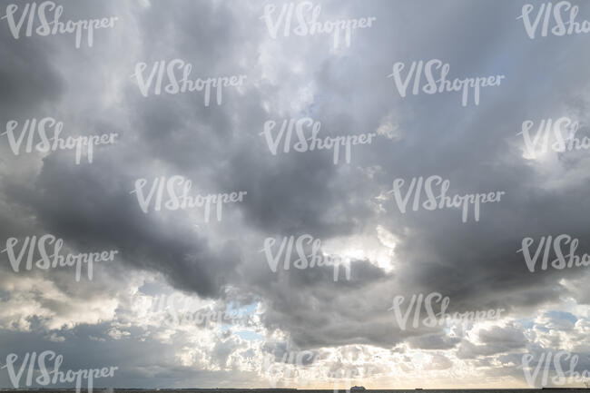 sky with grey clouds and sun rays