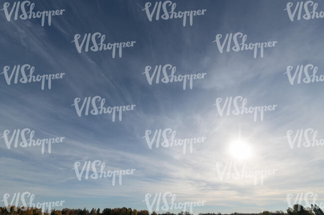 daytime sky with sub and thin clouds