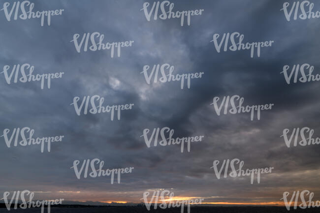 dramatic sunset with dark clouds