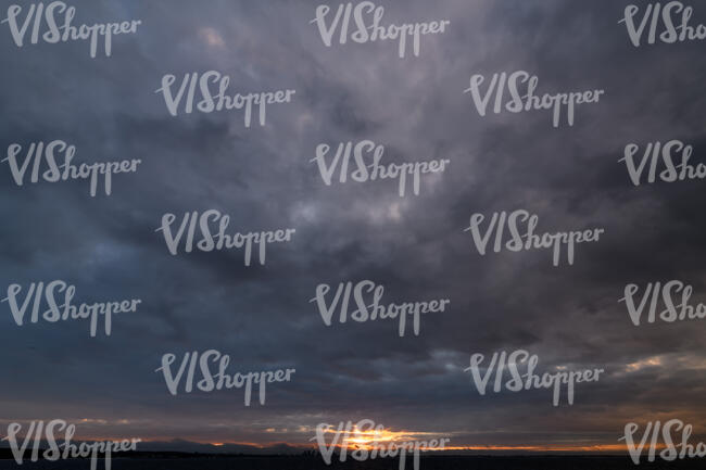 dramatic sunset with very dark clouds